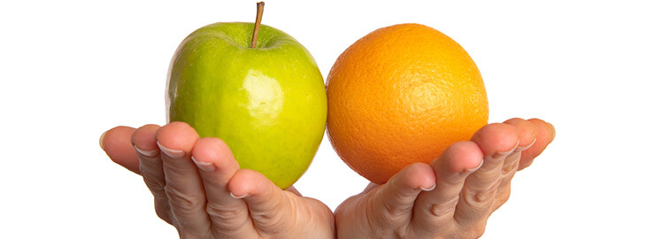 hands holding an apple and an orange together