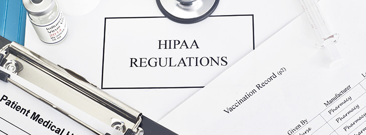 HIPAA Regulations document among vaccination records and patient medical history paperwork