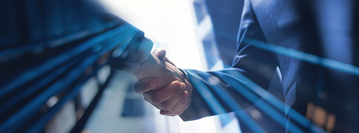 businessman and CISO shaking hands outside of an office building